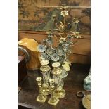 A pair of brass and copper twin branch candle stands with folk art flower decoration a similar brass