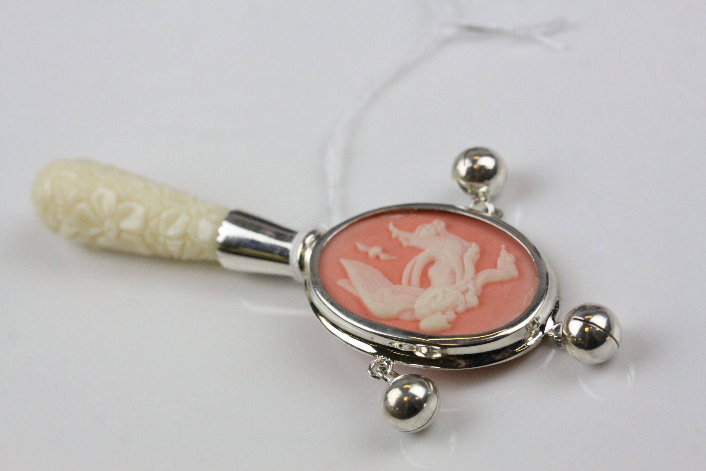 A silver babies rattle in the Wedgewood style set with bone handle