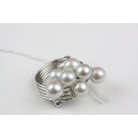 A silver brooch set with a cluster of pearls