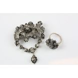 Indian White Metal Brooch and Matching Ring, both profusely fashioned as floral and fauna and set