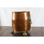 Large Copper Planter / Log Basket with Brass Lion Mask Ring Handles and raised on Three Brass Lion