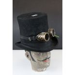 Steam Punk Style Mannequin Head wearing a Black Wool Top Hat with Goggles and fabric flowers