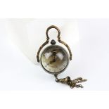 A miniature brass ball clock