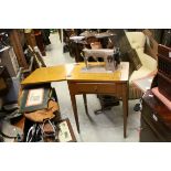 Mid 20th century Electric Singer Sewing Machine housed within an Oak Table Cabinet with