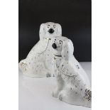 A pair of large ceramic Staffordshire spaniel dogs.