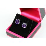 A pair of silver and amethyst stud earrings