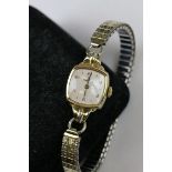 A ladies 9ct gold cased Omega cocktail watch with stainless steel flexi strap.