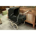 Marmet coach built pram with sprung suspension, dark green coachwork and hood, height to handle