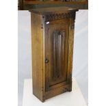 Slim Oak ' Old Mill ' Hall Cupboard, the single linenfold carved door opening to reveal shelves, h.