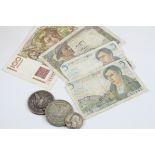 A collection of French 1940's banknotes together with two American silver dollars dated 1880 &