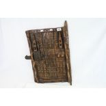 Ethnic / Tribal Hardwood Door with Latch, the carving depicting figures and symbols, approximately