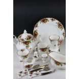 A comprehensive Royal Albert Country Roses dinner service to include 12 Dinner Plates, 12 Tea