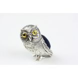 A silver pin cushion in the form of an owl