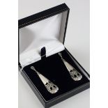 A pair of silver drop earrings set with mother of pearl and marcasites