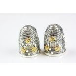 A pair of silver plated condiments in the form of beehives