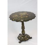 19th century Black Lacquered Table, the shaped circular top decorated with flowers raised on