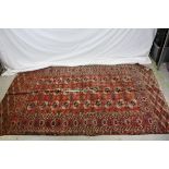 Red Ground Rug with Geometric Pattern within a Border, 211cms x 123cms (a/f)