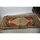 Eastern Wool Rug decorated with a geometric pattern centre surrounded by figures and animals