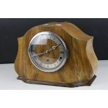 A 1940s burr wood fronted mantle clock with three train westminster chime movement.