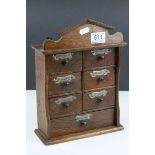 An early 20th century free standing oak spice cabinet of small dimensions in the form of a cabinet