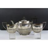A fully hallmarked sterling silver tea set by Walker & Hall to include matching tea pot, milk jug