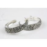 A pair of silver hoop earrings set with marcasites