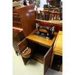 Mid 20th century Electric Singer Sewing Machine housed within an Oak Table Cabinet, h.79cms w.53cms