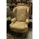 Floral Upholstered Wing Back Armchair raised on Cabriole Legs