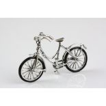 A silver figure of a bicycle