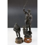 Spelter figure of a blacksmith at work together with a Peter Hicks figure of a soldier.