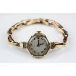 A ladies 9ct gold cased cocktail watch on a 9ct gold strap.
