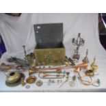 Chest containing group of copper and brass items to include horns, candlesticks etc