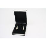 A pair of silver pearl drop earrings
