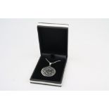 A silver pendant necklace with masonic symbol