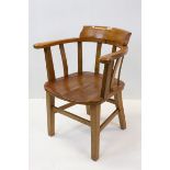 A vintage elm seated Captains chair