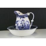 A blue and white willow pattern jug and bowl.