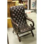 Victorian Style Brown Buttoned Leather and Brass Studded Armchair, h.97cms