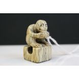 A Chinese ivory monkey seal, seated on a square base with characters below, H: 3.5 cms