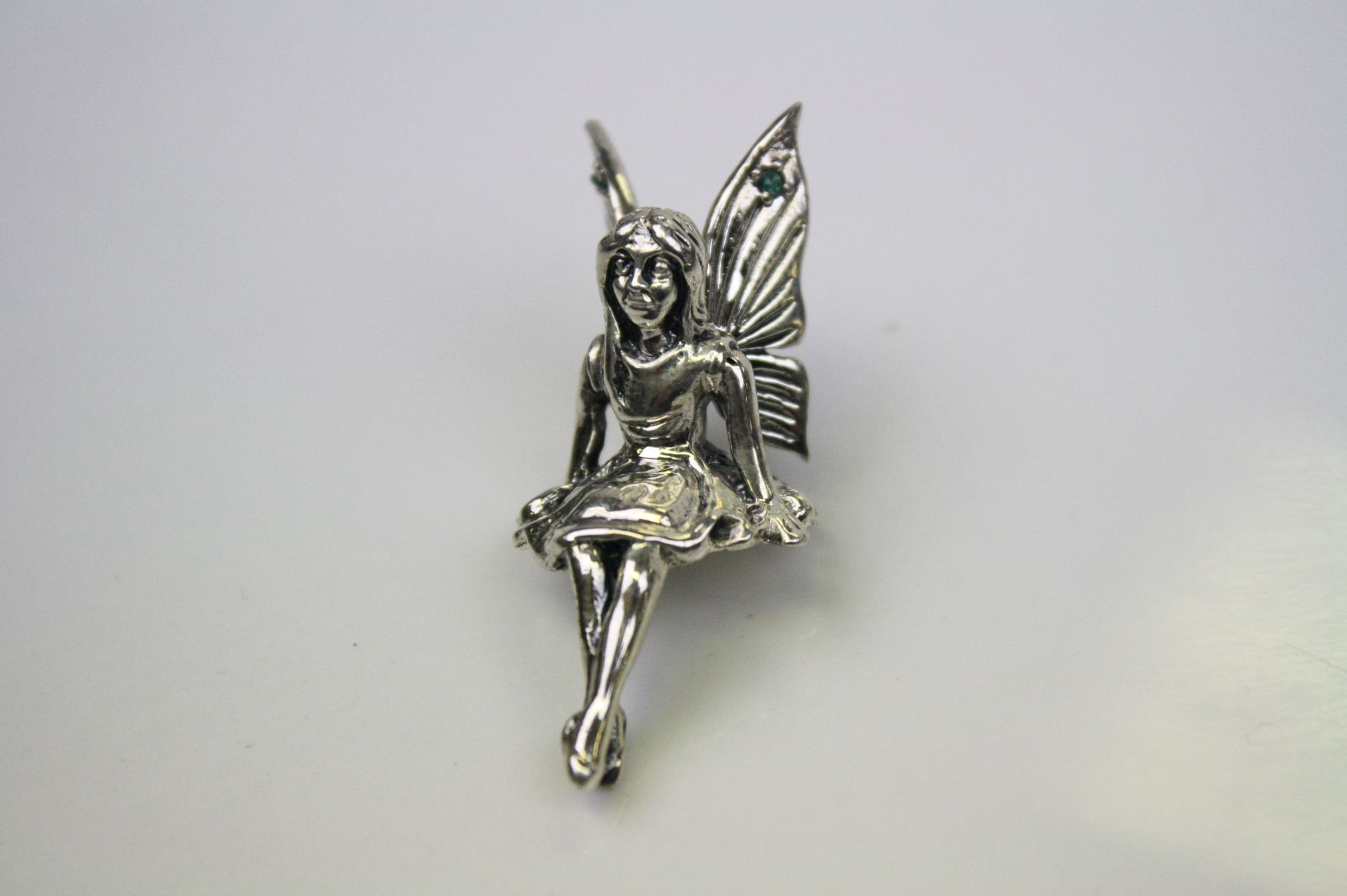 A silver figure of a fairy
