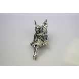 A silver figure of a fairy