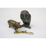 A small lot of collectables to include a white metal owl ornament, a brass pig vesta case and a