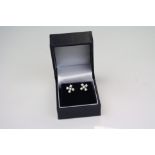 A pair of silver and CZ cross earrings