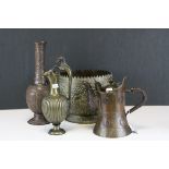 Three copper and brass jugs and a planter of Asian origin