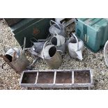 Six Galvanised Watering Cans plus a Feed Trough