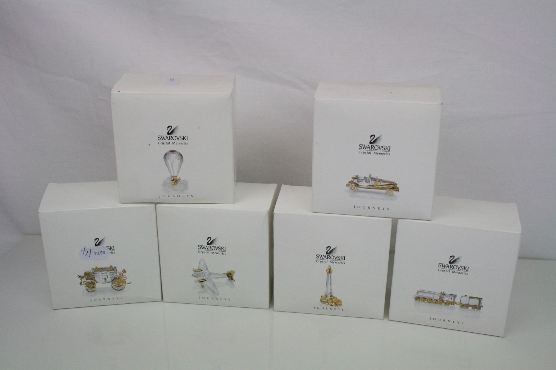 Collection of six Swarovski crystal memories 'Journeys' in gold with original boxes