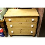 19th century pine chest of drawers on bun feet and china handles