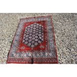 Red Ground Wool Rug with Geometric Pattern, approx.184cms x 120cms