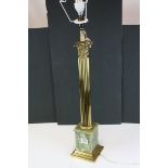 Large brass Corinthian Column table lamp raised on a green onyx base.