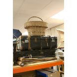 A metal tin trunk, a wooden bound trunk, wicker basket together with three croquet mallets, a