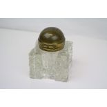 A antique cut glass inkwell with brass hinged lid dated 1900.